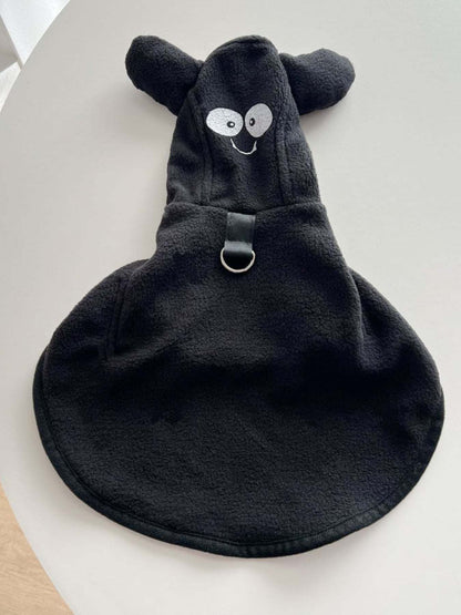 Pet wearing a cozy hooded costume coat for warmth and fun
