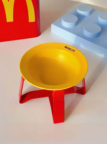 Red airtight pet food storage container with yellow logo and attached scoop