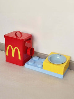 Red pet food storage container with hinged lid and attached scoop